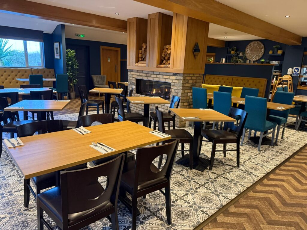 Tables set beside the fire at The Canalside