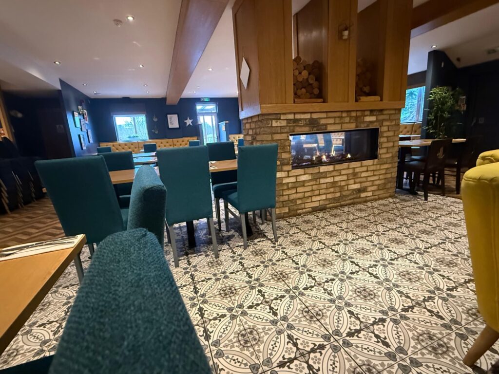 Teal chairs by the fire at The Canalside